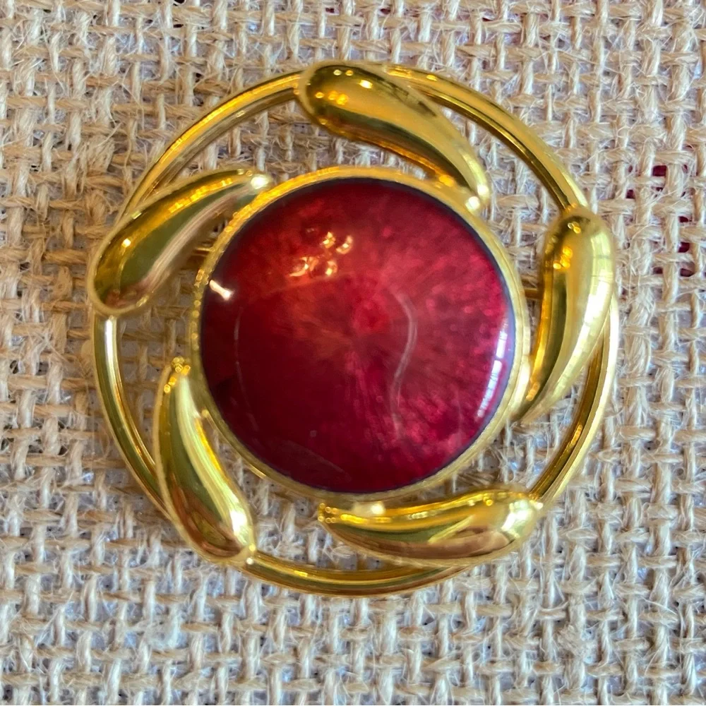 Convertible brooch and pendant circle with red enamel center in goldtone metal